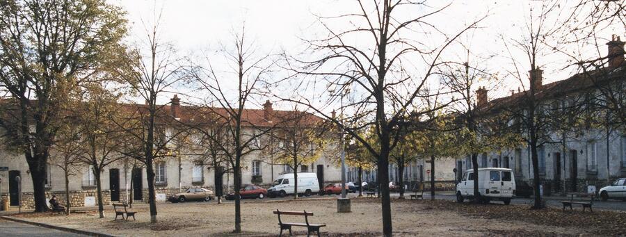 A leafy square, surrounded by low-rise housing in suburban Bordeaux.